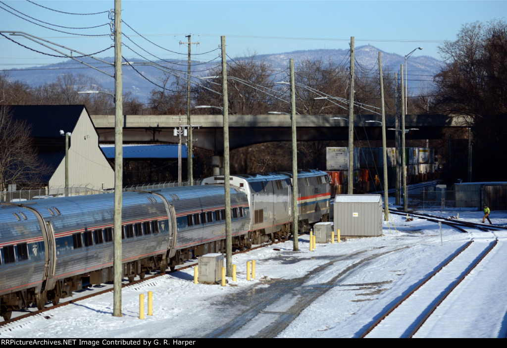 Amtrak #20(2) faces north in the early morning sun of January 4.  5th St. bridge, Tobacco Row Mtn. and a snow-delayed NS intermodal in the background.